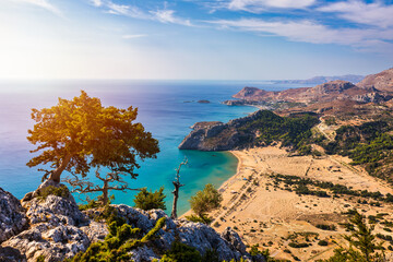 Tsampika beach with golden sand view from above, Rhodes, Greece. Aerial birds eye view of famous beach of Tsampika, Rhodes island, Dodecanese, Greece