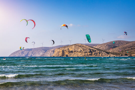 Surfers in Prasonisi Beach in Rhodes island, Greece. Kiteboarder kitesurfer athlete performing kitesurfing kiteboarding tricks. Prasonisi Beach is popular location for surfing. Greece