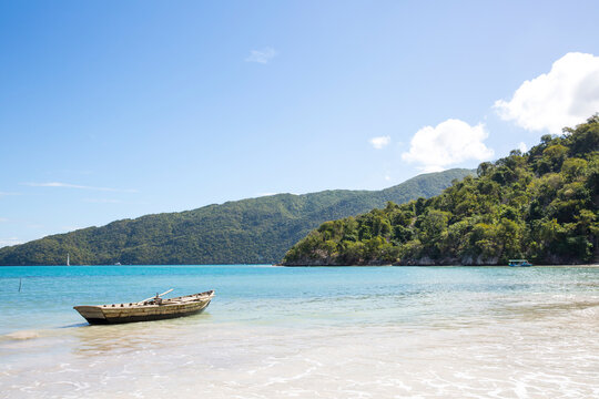 Tranquil view of mountains by sea against sky