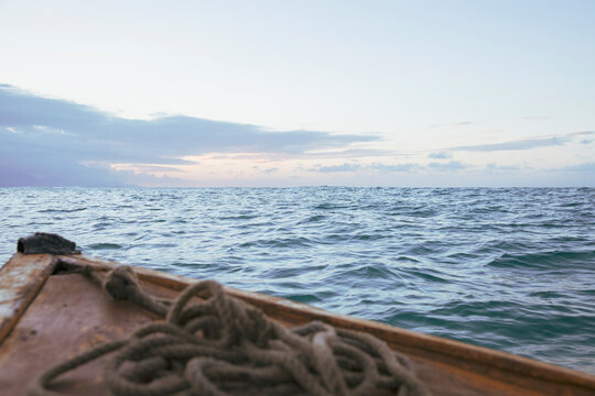 Boat sailing in sea against sky during sunset
