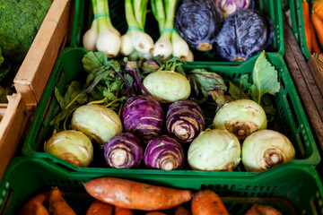 High angle view of vegetables in crates for sale at market stall