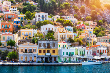 View of the beautiful greek island of Symi (Simi) with colourful houses and small boats. Greece,...