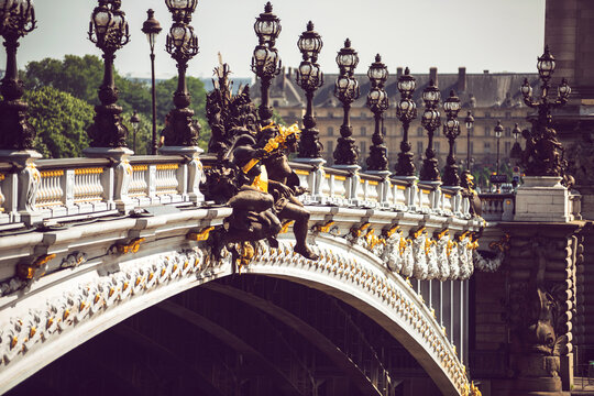 Statues on Alexandre III Bridge in city
