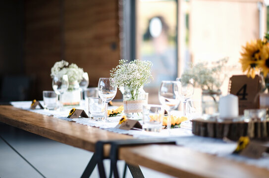 Flowers With Drinking Glasses And Name Tags Arranged On Dining Table In Wedding Ceremony