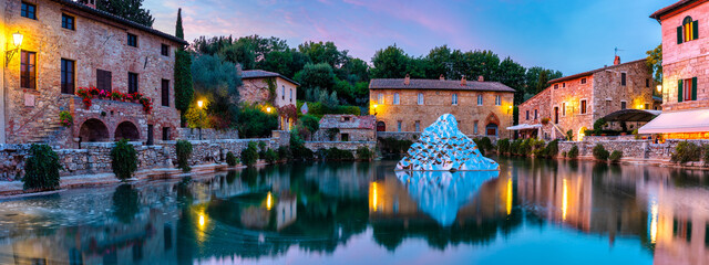 Obraz premium Thermal bath town of Bagno Vignoni, Italy during sunrise. Old thermal baths in the medieval village Bagno Vignoni, Tuscany, Italy. Medieval thermal baths in village Bagno Vignoni, Tuscany, Italy