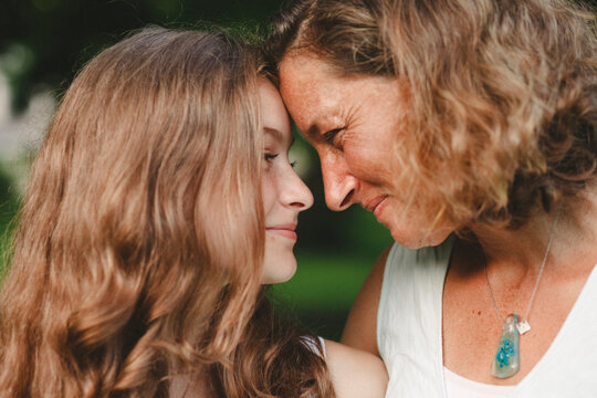 Close-up of mother and daughter looking at each other in park