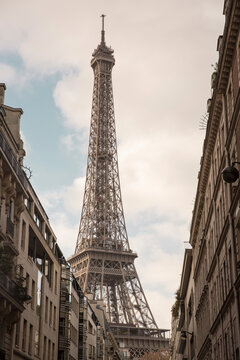 Low angle view of Eiffel Tower against cloudy sky in city