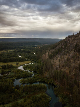 Scenic view of river amidst landscape against cloudy sky during sunset