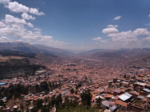 Aerial view of townscape against sky during sunny day