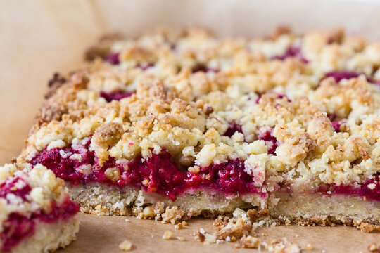Close-up of crumble pie with jam served on table