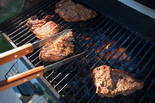High angle view of beef cooking on barbecue grill