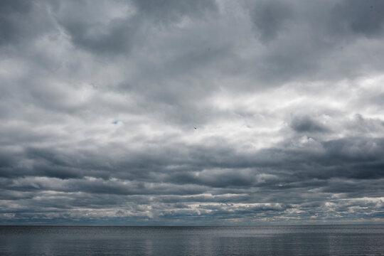Idyllic view of seascape against stormy clouds