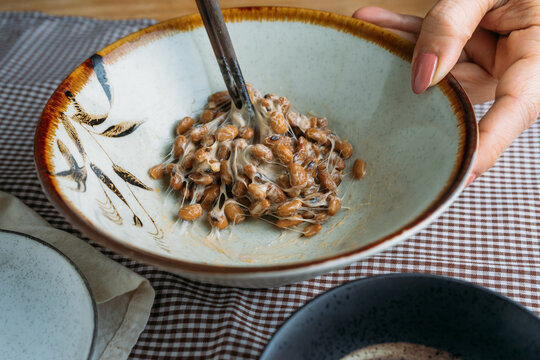 Cropped hand of woman mix a nattō in bowl