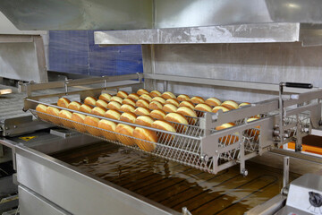 High angle view of buns in containers on production line at factory