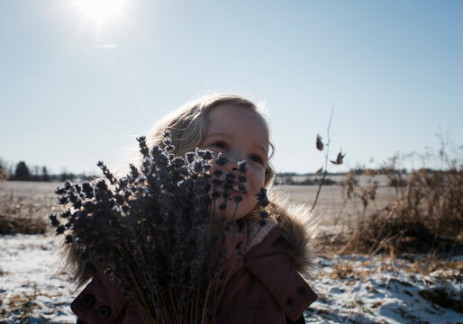 young girl outdoors with a bunch of lavender