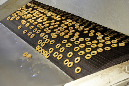 High angle view of sweet food processing on conveyor belt in factory