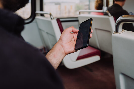 Man Riding Metro Train And Reading Phone