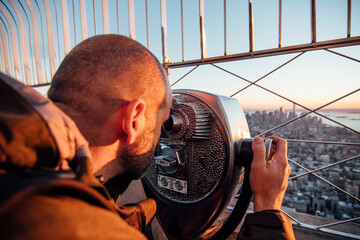 A man looking with binocular in New York