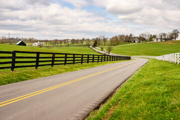 Winding two-lane rural road in bluegrass region of Kentucky