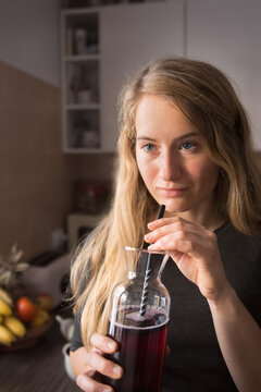 Young woman relax and drink lemonade fruit in glass carafe