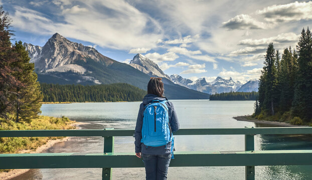 woman looking  by lake at Maligne Lake in Jasper National Park