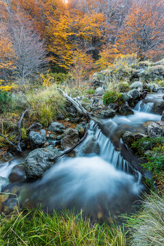 Small waterfall over mountain stream in the Andes Mountains in autumn