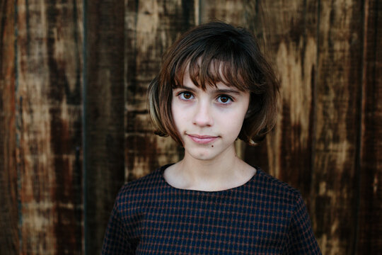 Portrait of a young teen in front of wooden background