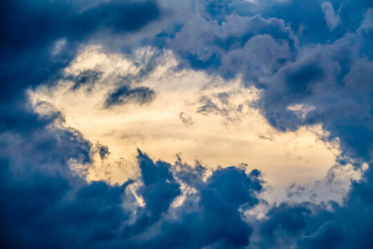 Break in fast-moving storm clouds at sunset near the start of summer