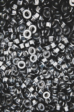 Lot of shiny metal nuts for a bolt