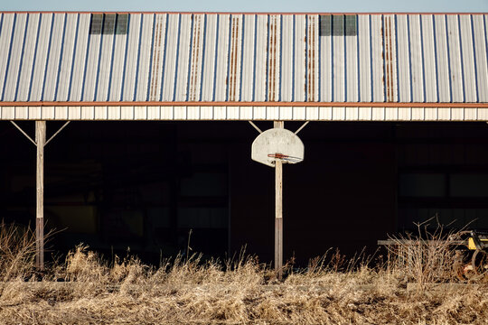 Basketball hoop and backboard on exterior of shed on a Midwestern farm