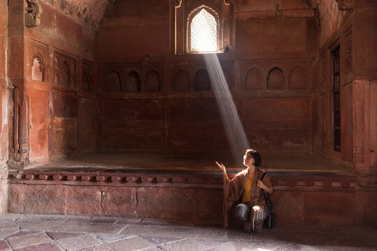 30 years old caucasian girl hit by a ray of sun inside Agra Fort India