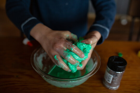 Boy mixing slime up with his hands
