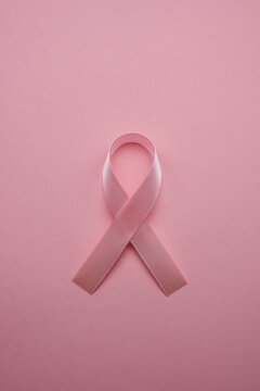 pink ribbon breast cancer on pink background. Copy space
