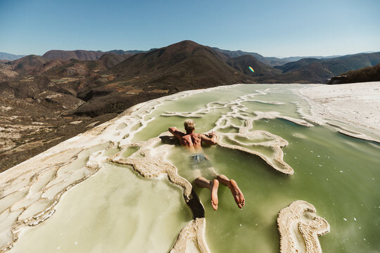 relaxing tourist starts to get up from soaking in oaxaca cold springs