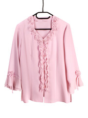 Isolated vintage light pink blouse with decorative roses on a hanger, women's fashion.