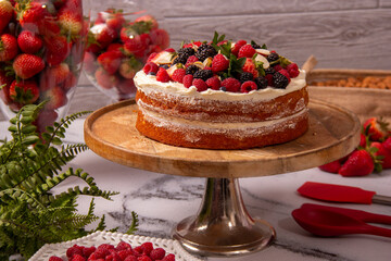 Cake decorated with whipped cream and red berries, keto diet recipe