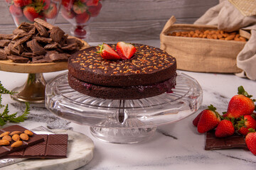 Chocolate cake with walnuts decorated with strawberries