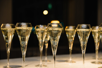 set of champagne glasses on table top (golden light bubbly fine wining in a restaurant)