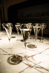 set of champagne glasses on table top (golden light bubbly fine wining in a restaurant)