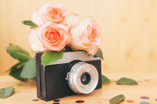Beautiful vintage card	with old film camera and rose flowers and decoration