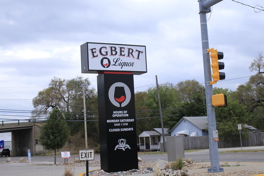 EGBERT Liquor sign by a road with sky