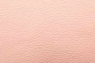 Texture of light pink leather as background, closeup