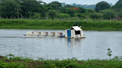 Aeration machine in a pond at a fish farm, at the La Segua Wetlands near Chone, Ecuador