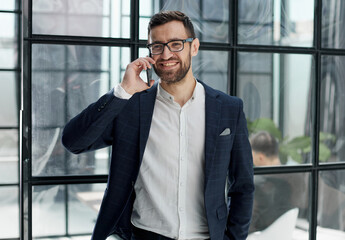 Fototapeta premium businessman with glasses talking on the phone