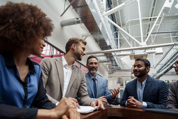 Multiethnic group of business people talking in office during break. Teamwork concept