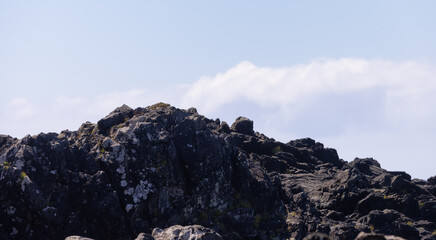 Rugged Rocks on a rocky shore on the West Coast of Pacific Ocean. Summer Morning Sky. Ucluelet, Vancouver Island, British Columbia, Canada. Nature Background