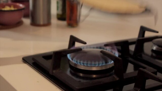 Putting an arepa on the stove to roast