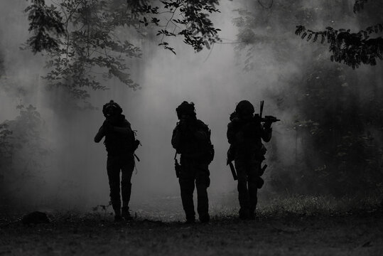 Military Historical reconstruction soldiers fighting during. US Army soldier soldiers in a cloud of smoke.