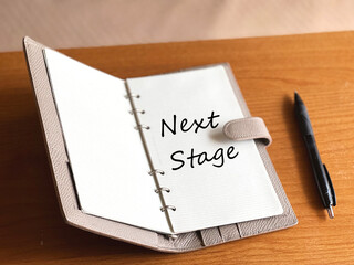開いた手帳とボールペン_NextStage文字入り