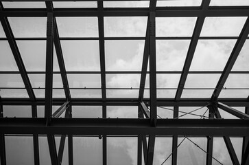 Monochrome Cantilever Steel Beams with Translucent Glass Skylight.